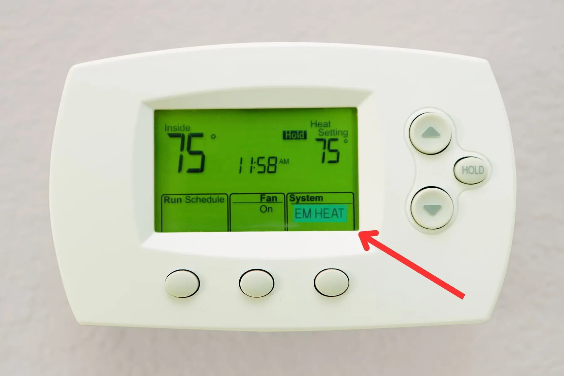 Thermostat showing EM heat is switched on