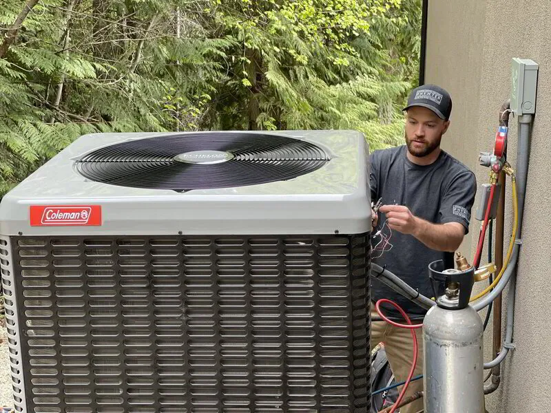 AC technician working on an outdoor unit