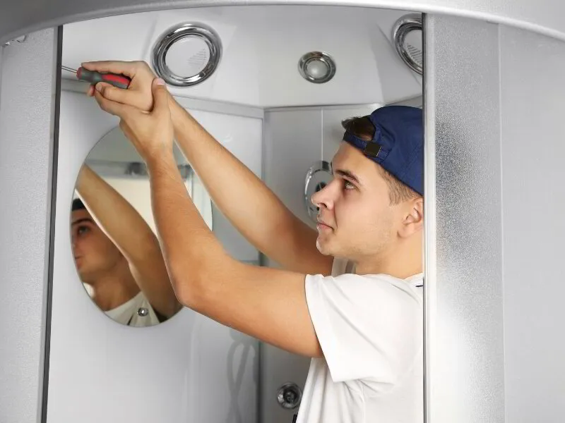 plumber installing a shower door