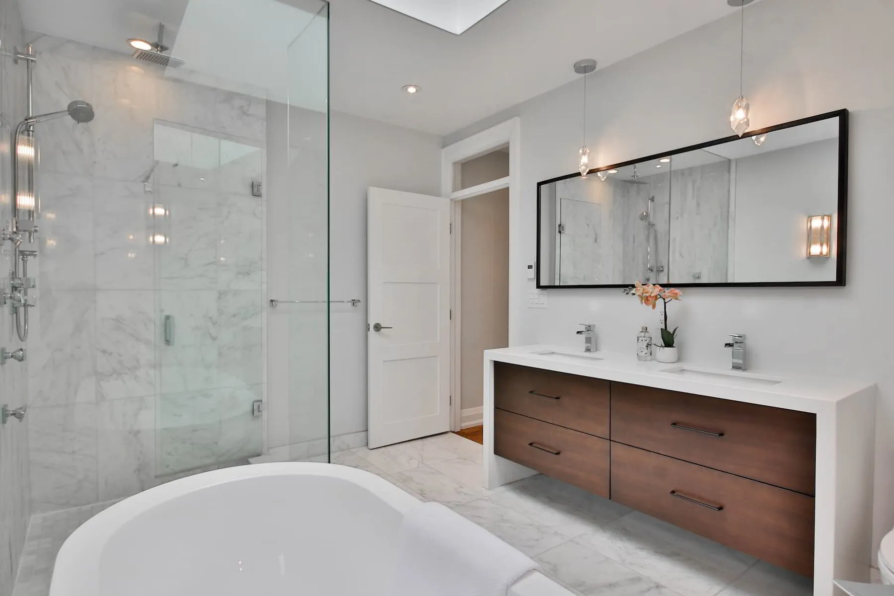well lit bathroom with glass partition