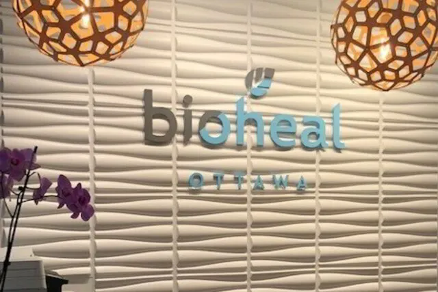 bioheal reception desk logo on textured wall