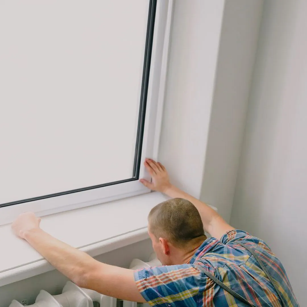 Man werkend aan een witte ramen en deuren