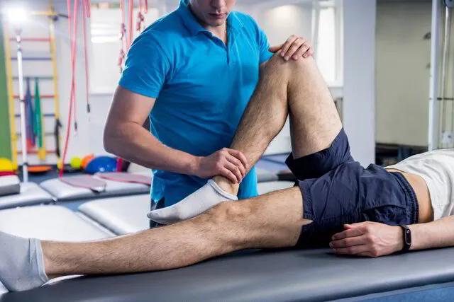 doctor checking patients knee reflexes