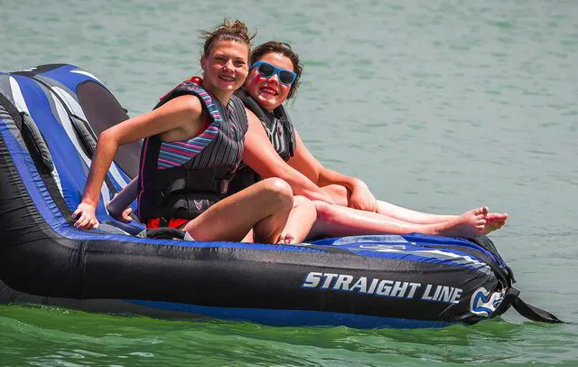 Two people riding a tube on Lake Powell