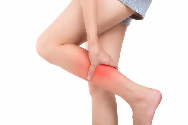 A woman experiencing leg pain