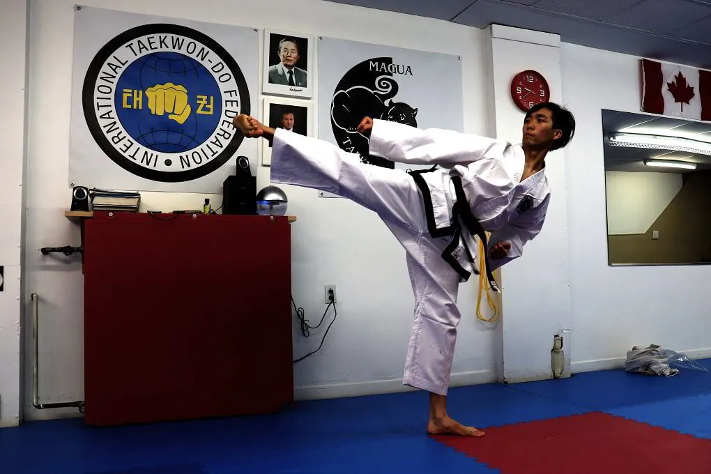 Albert Chan performing a side kick at the Magua Taekwon-Do School