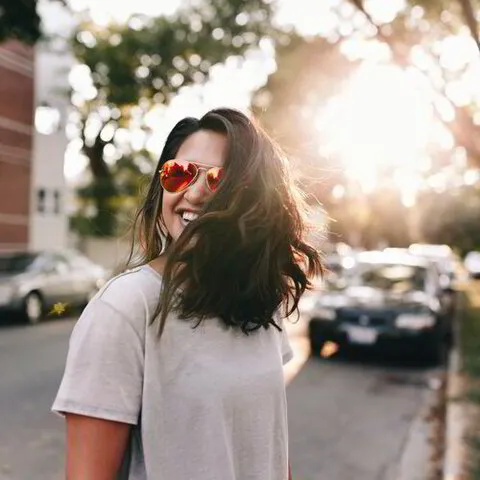 cheerful woman wearing sunglasses