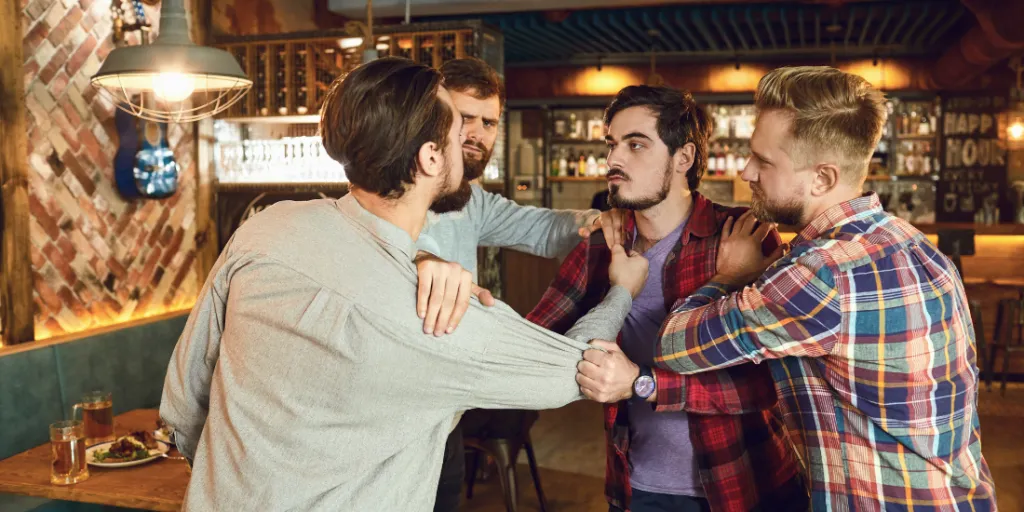 two men separating two other angry men