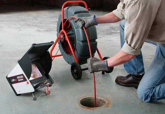 A camera video inspection being performed on a sewer by a professional plumber