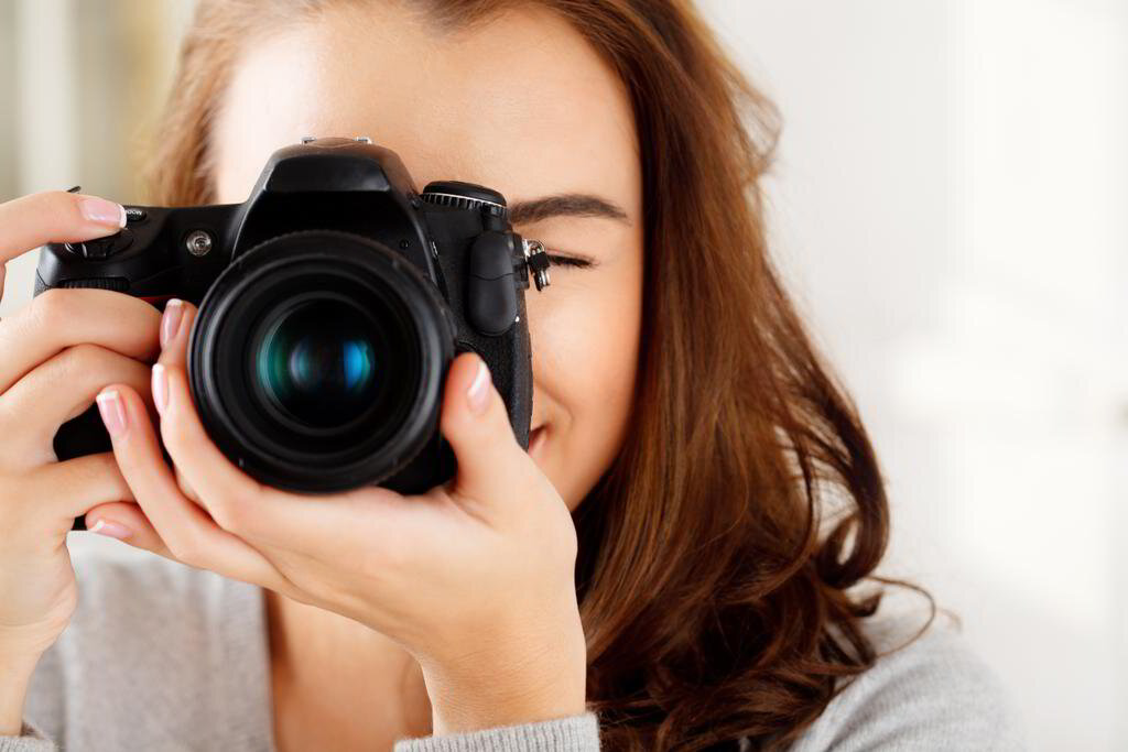 female holding a camera