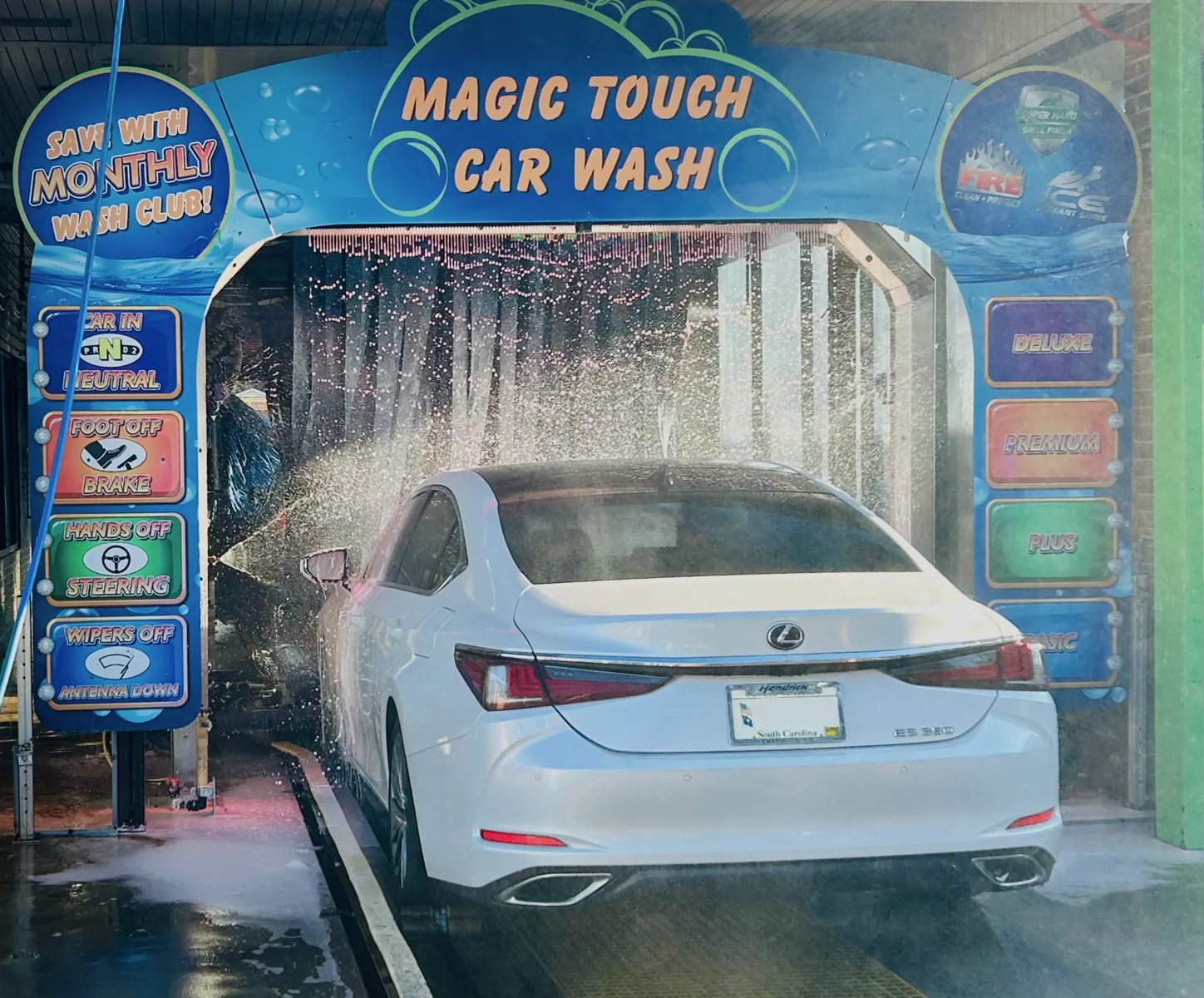 White car going through Magic Touch wash tunnel