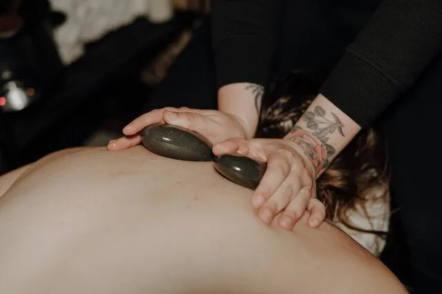 Owner performing a hot stone massage in Mesa