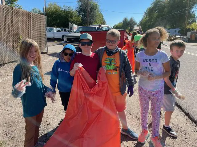 students picking up trash in their community