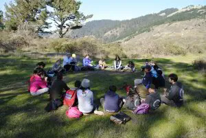 students sitting outdoors in a circle