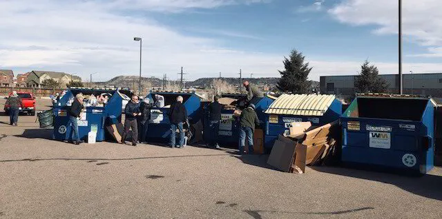 people at recycle bins 