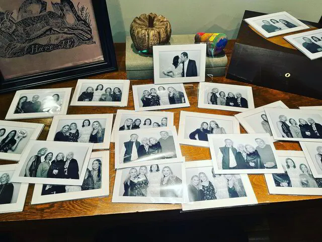 table full of glam black and white print photos