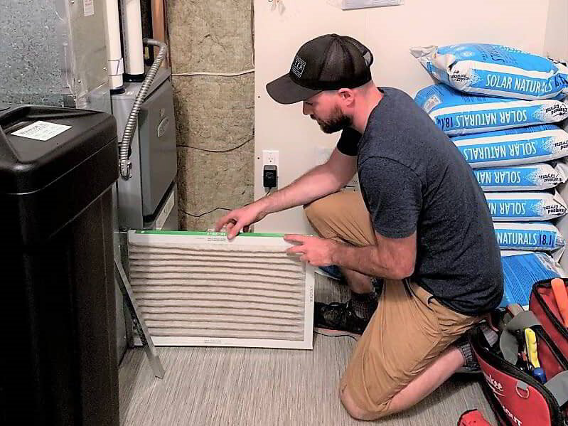 Phyxter HVAC technician checking furnace air filter