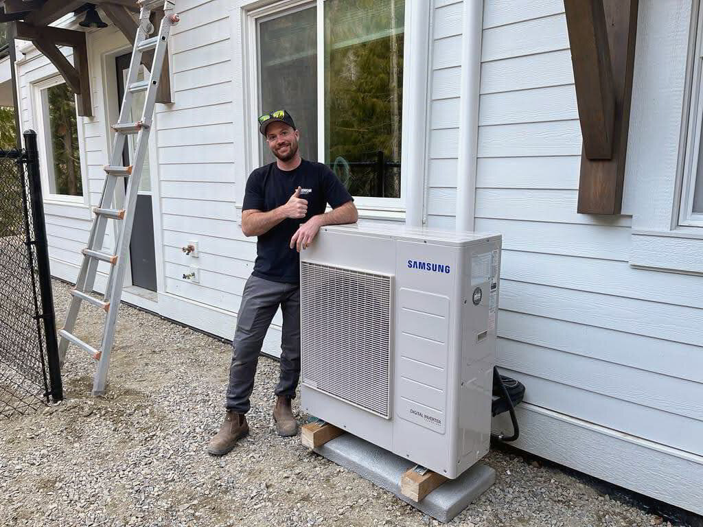 HVAC manager leaning on new AC installation