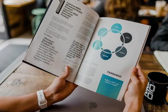 Someone reading an Infographic in a book