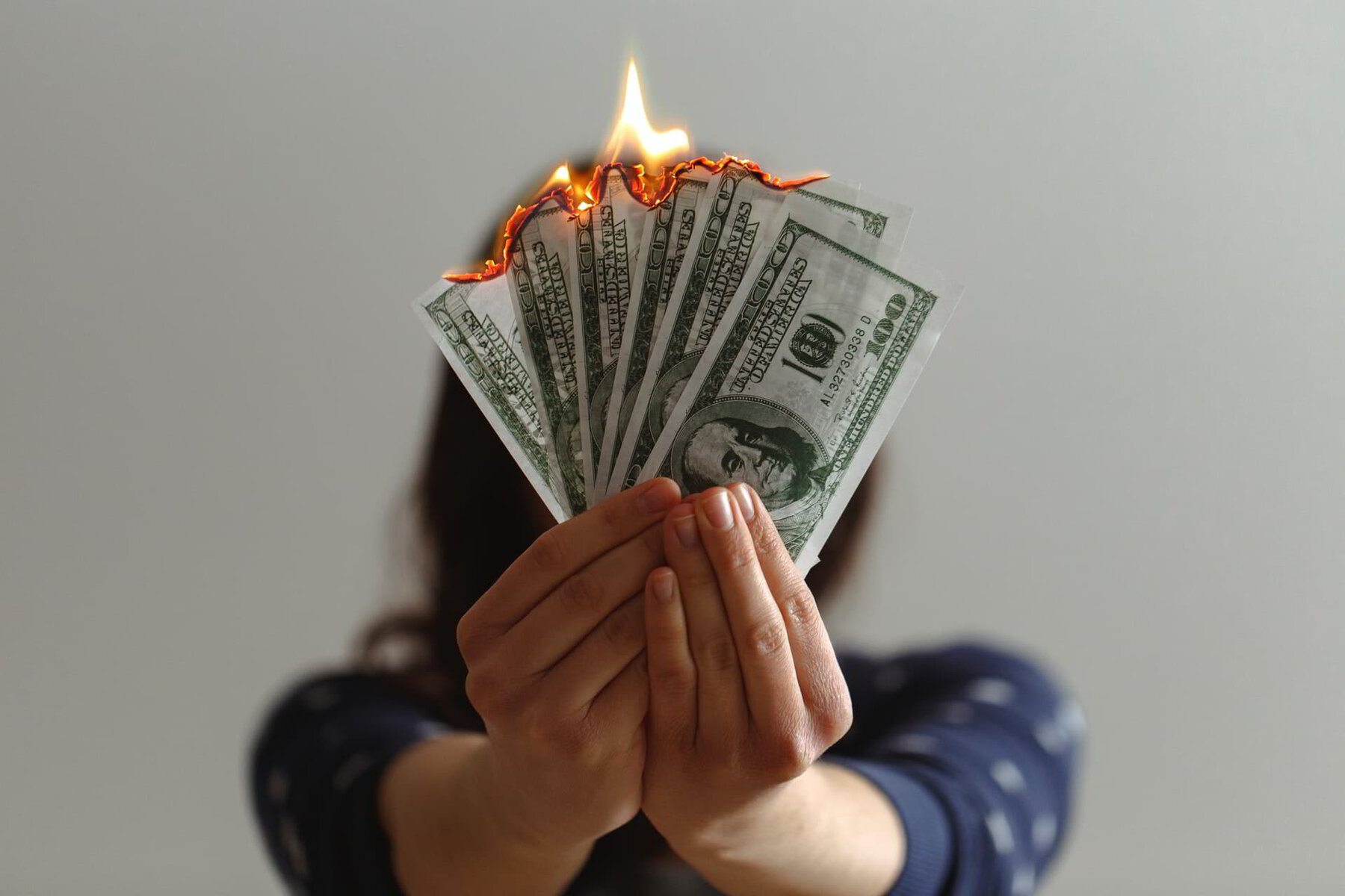 woman burning money on her energy bill