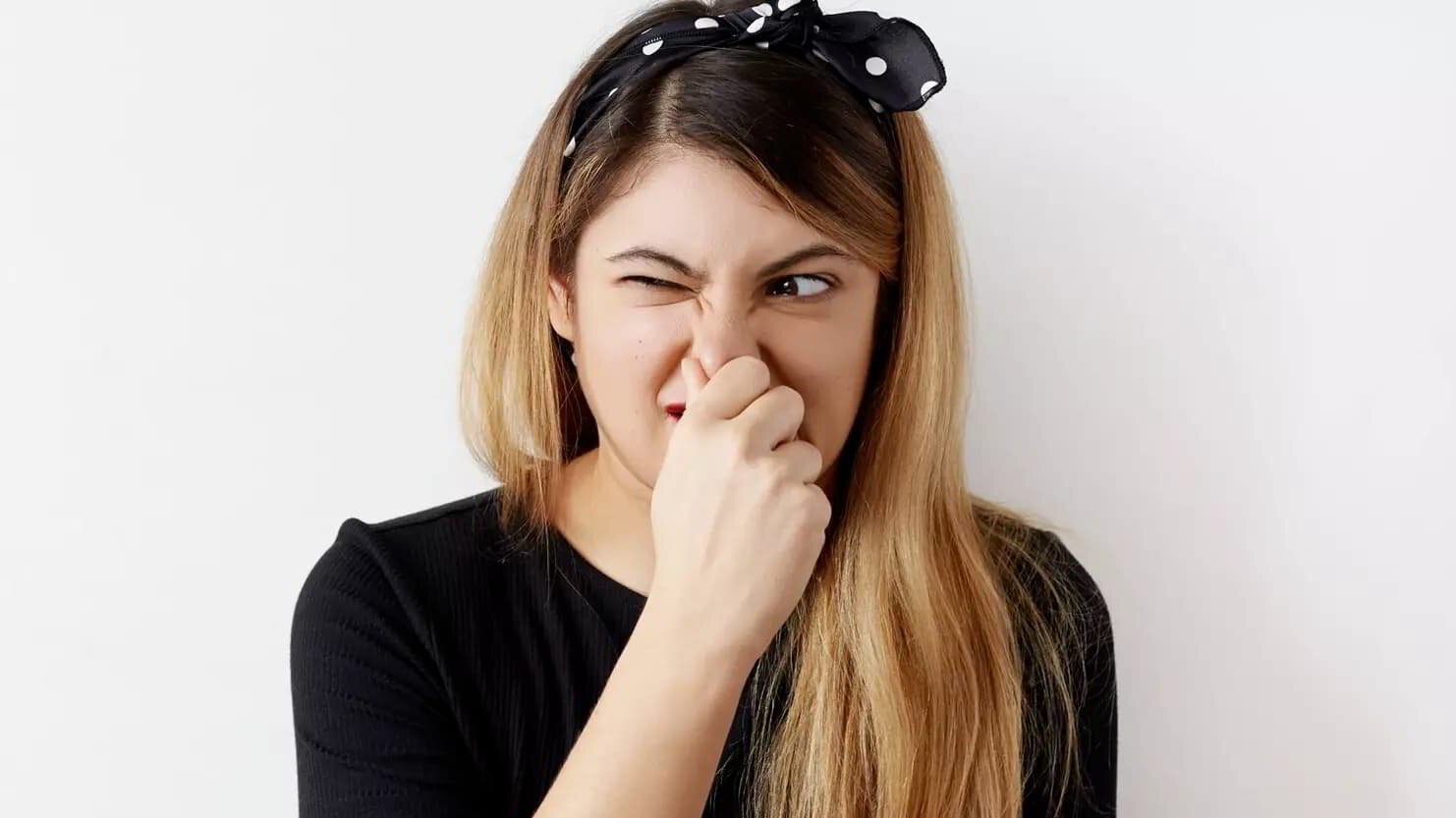 woman holding her nose due to a smelly AC