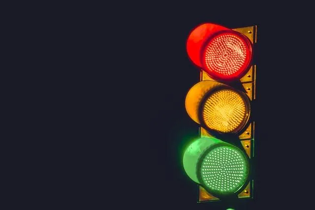 A traffic light at night time