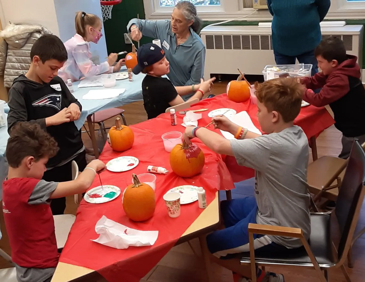 Church School kids painting pumpkins