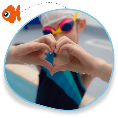 A child in a swimming lesson in Rugby, Warwickshire, wears goggles and makes a heart symbol with her hands