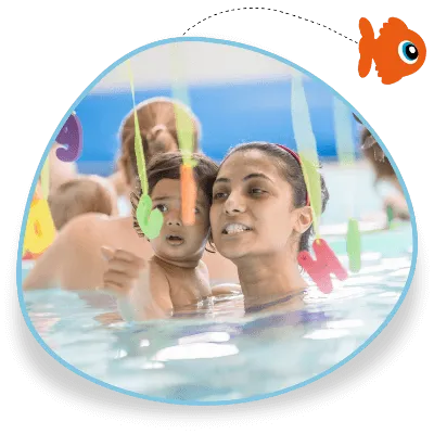 An adult and a toddler look at baby sensory toys together in a swimming pool