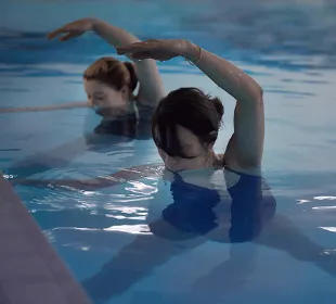 Mums-to-be are stretching in the water as part of an antenatal class