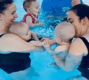A group of mums take part in a baby swimming class in Warwickshire at Swim Works