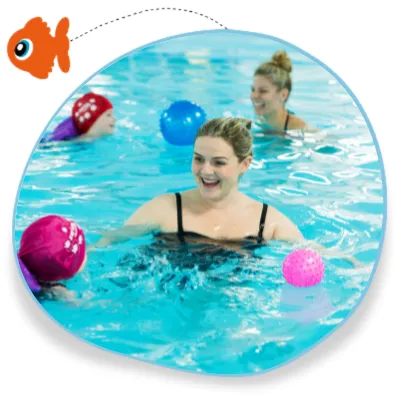 Children swim together in a lesson and they play with bright sensory balls