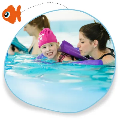 A grown up swims alongside her child in a swimming lesson in Leamington Spa