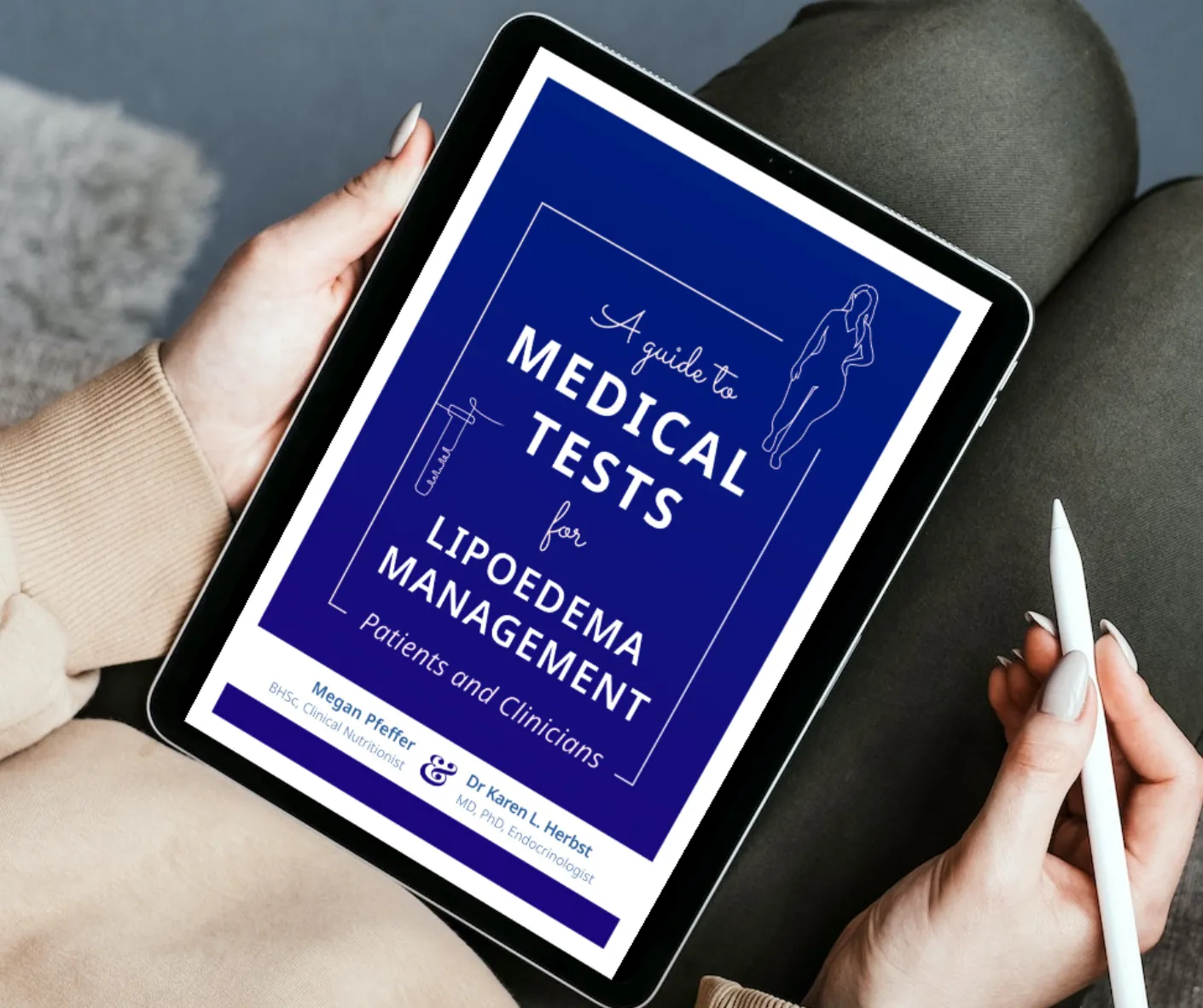 An ipad in a woman's lap with picture of Megan Pfeffer's book 'A guide to medical tests for lipoedema and lymphoedema'