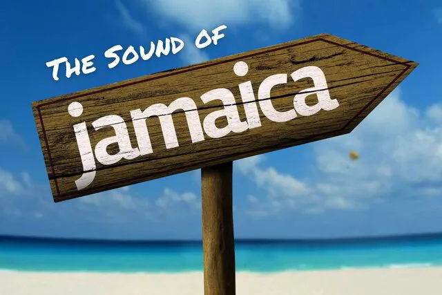 directional arrow on beach saying the sound of jamaica