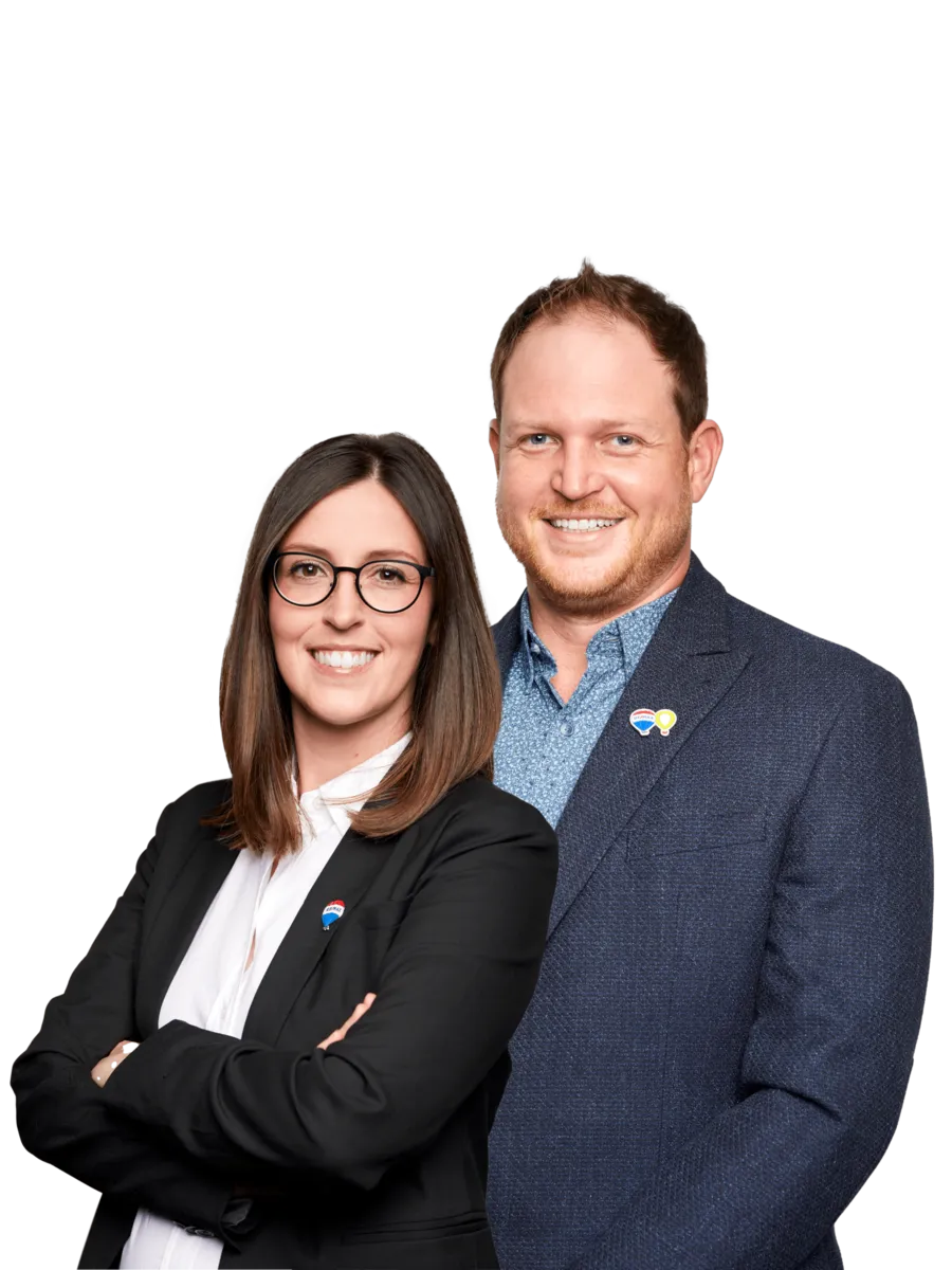 In this captivating team photo, the award-winning husband and wife real estate duo, Patrick and Kayla Kozierowski, exude confidence and success. The pair stands shoulder to shoulder, dressed in sharp professional attire that reflects their commitment to excellence in the real estate industry.