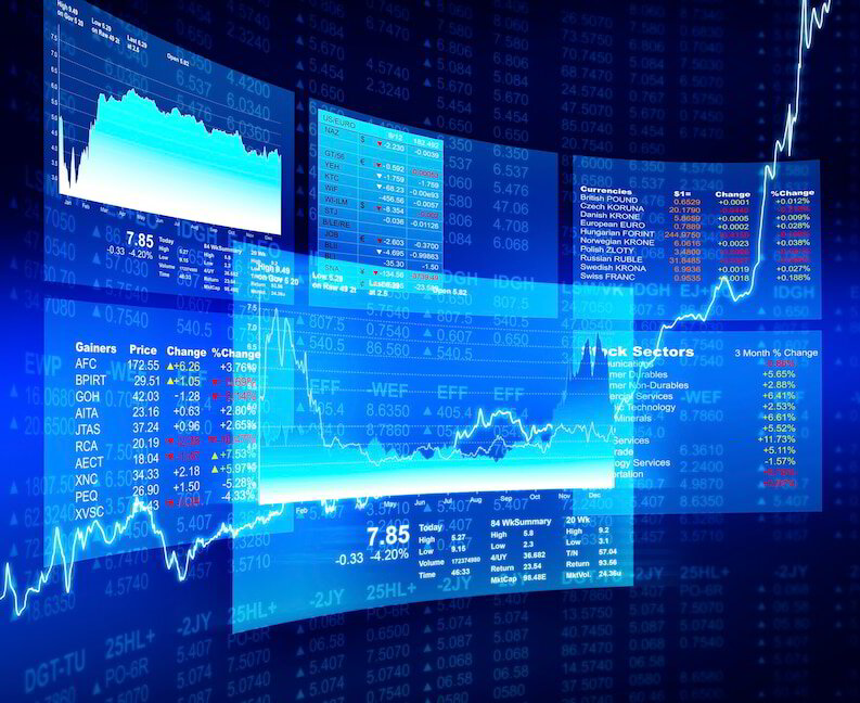 Financial analyst reviewing live stock market data on trading screens
