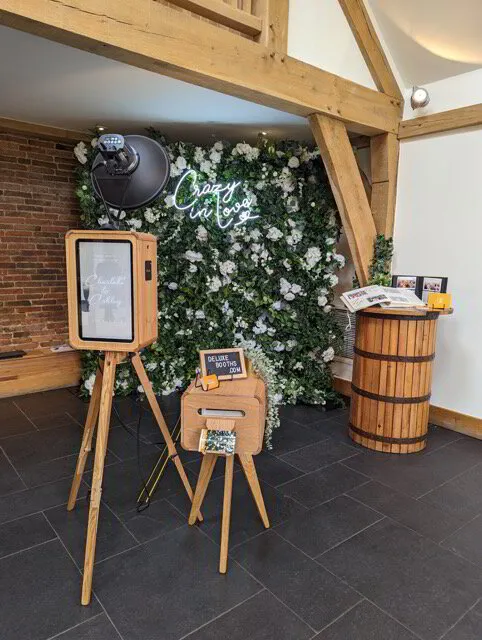 Photo booth at Mythe Barn Wedding Venue with luxury flower wall