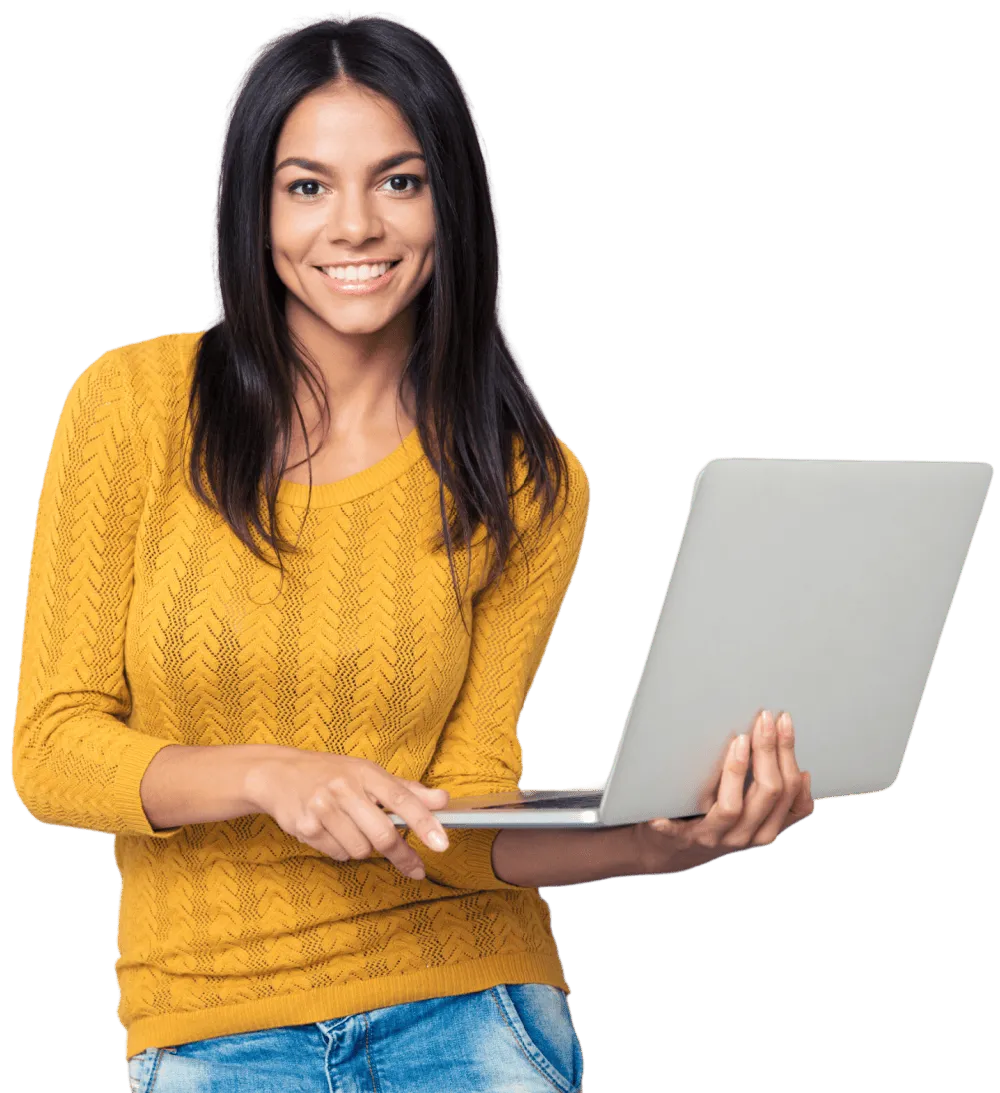 Happy female entrepreneur in a yellow sweater holding a laptop and smiling