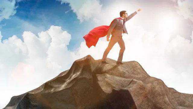 man_with_red_cape_on_top_of_mountain