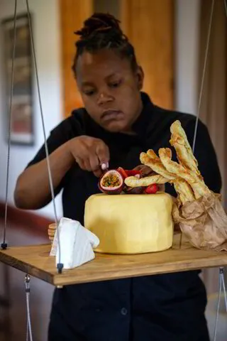 A waitress attending to a cake