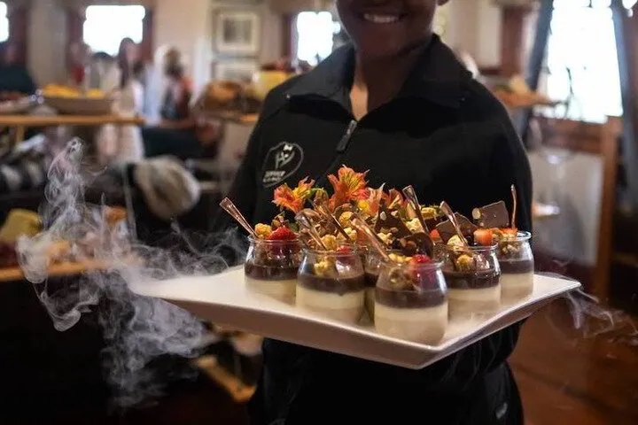 Service Excellence waitress with tray of desserts