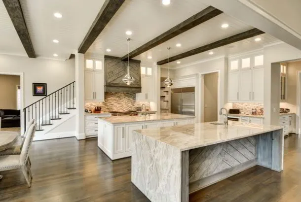 Wood beamed ceiling in kitchen with double islands