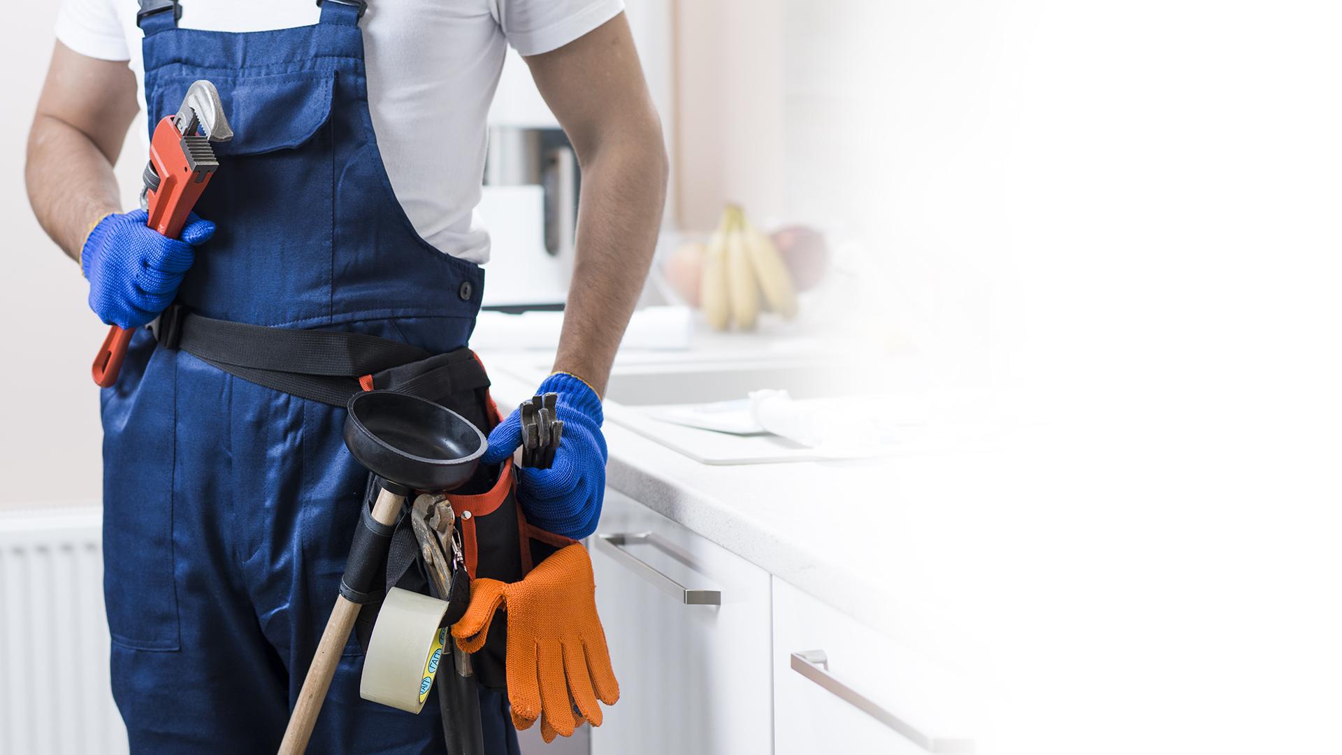 Plumber using CalendX scheduling software on a tablet
