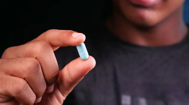 man holding a capsule