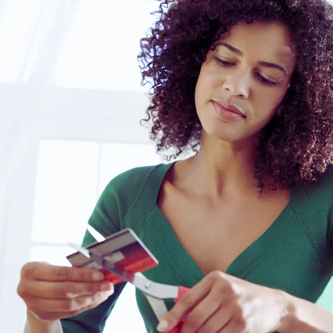 Lady cutting up Credit Card - iNDC