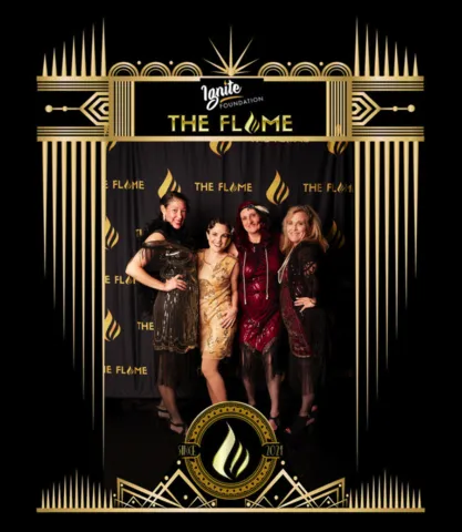 Photograph of Abby London and others at the 'Ignite the Flame' event, a roaring 20s themed gala where the political anti-pop singer-songwriter delivered a captivating performance.
