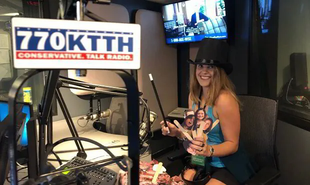 political anti-pop singer-songwriter Abby London during an interview and live studio performance of her political parody songs at KTTH Conservative Talk Radio, showcasing her engaging presence and innovative musical style.