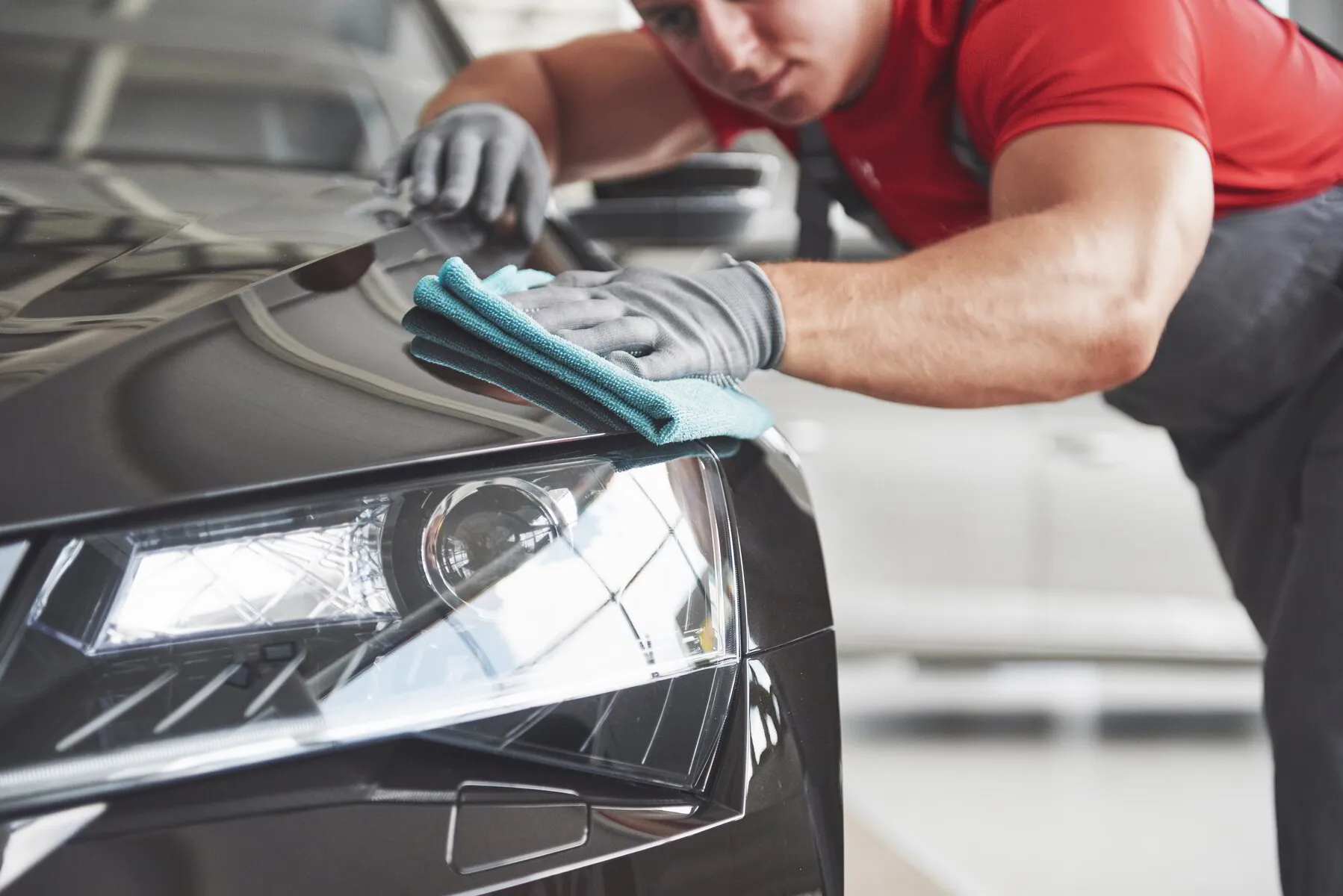 male employee detailing a car