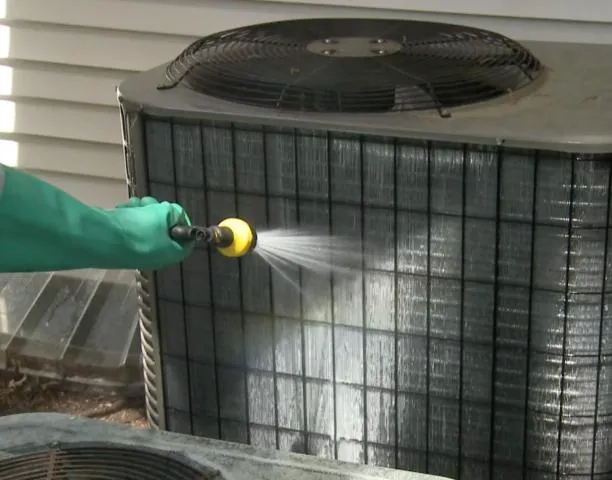 HVAC Technician cleaning a condenser coil